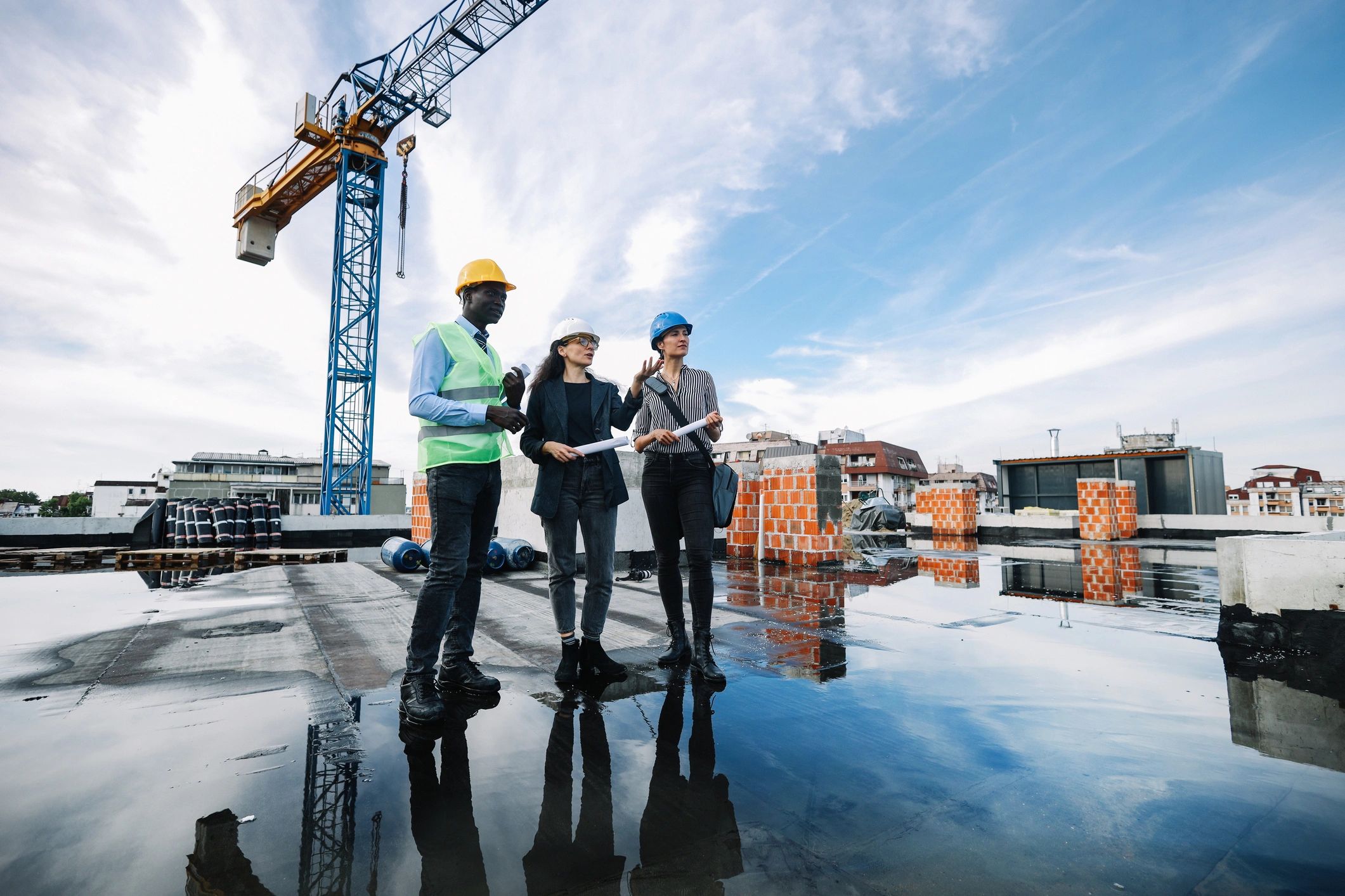 Construction team reviewing plans on a residential build site